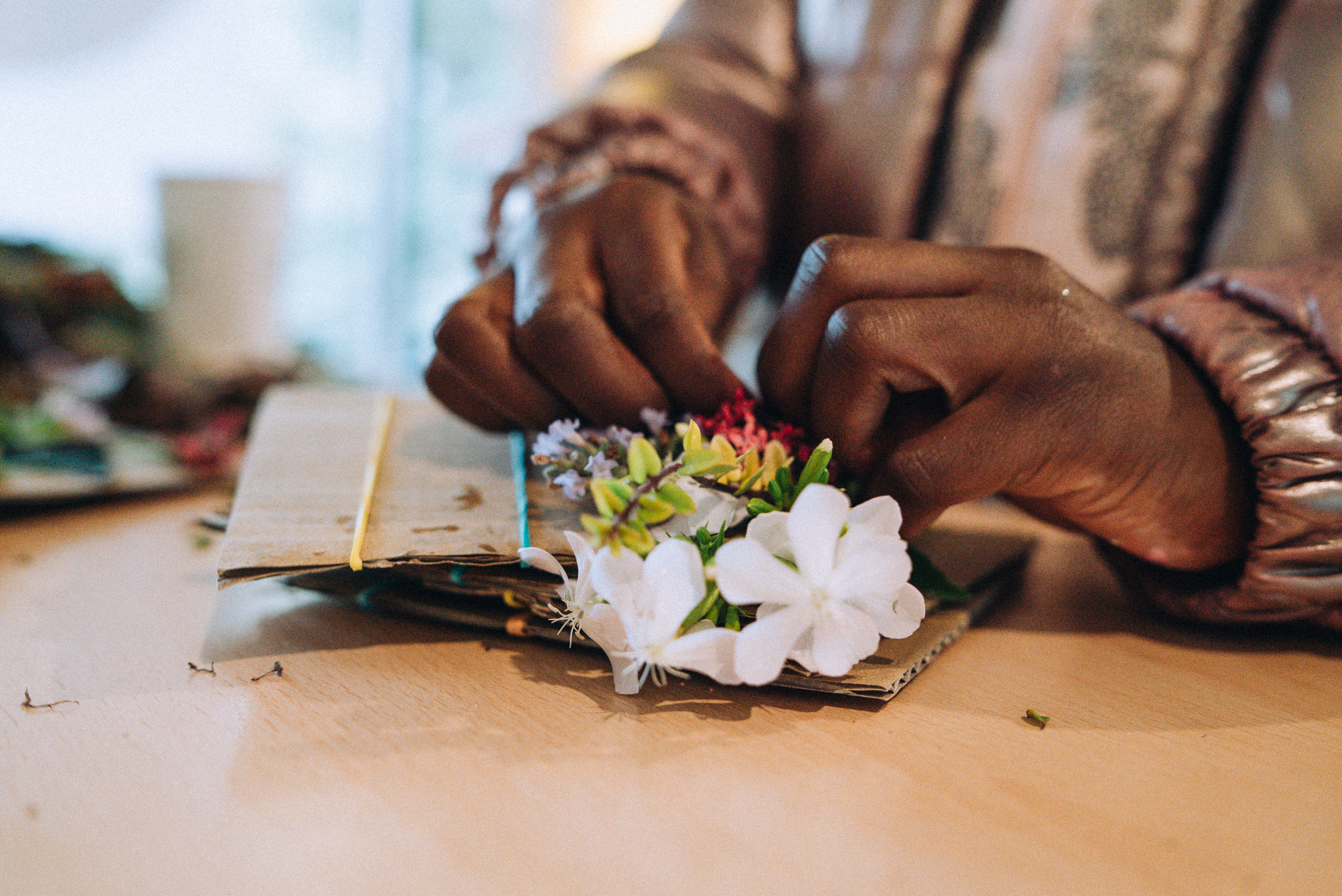 A woman's hands assembling some flowers
